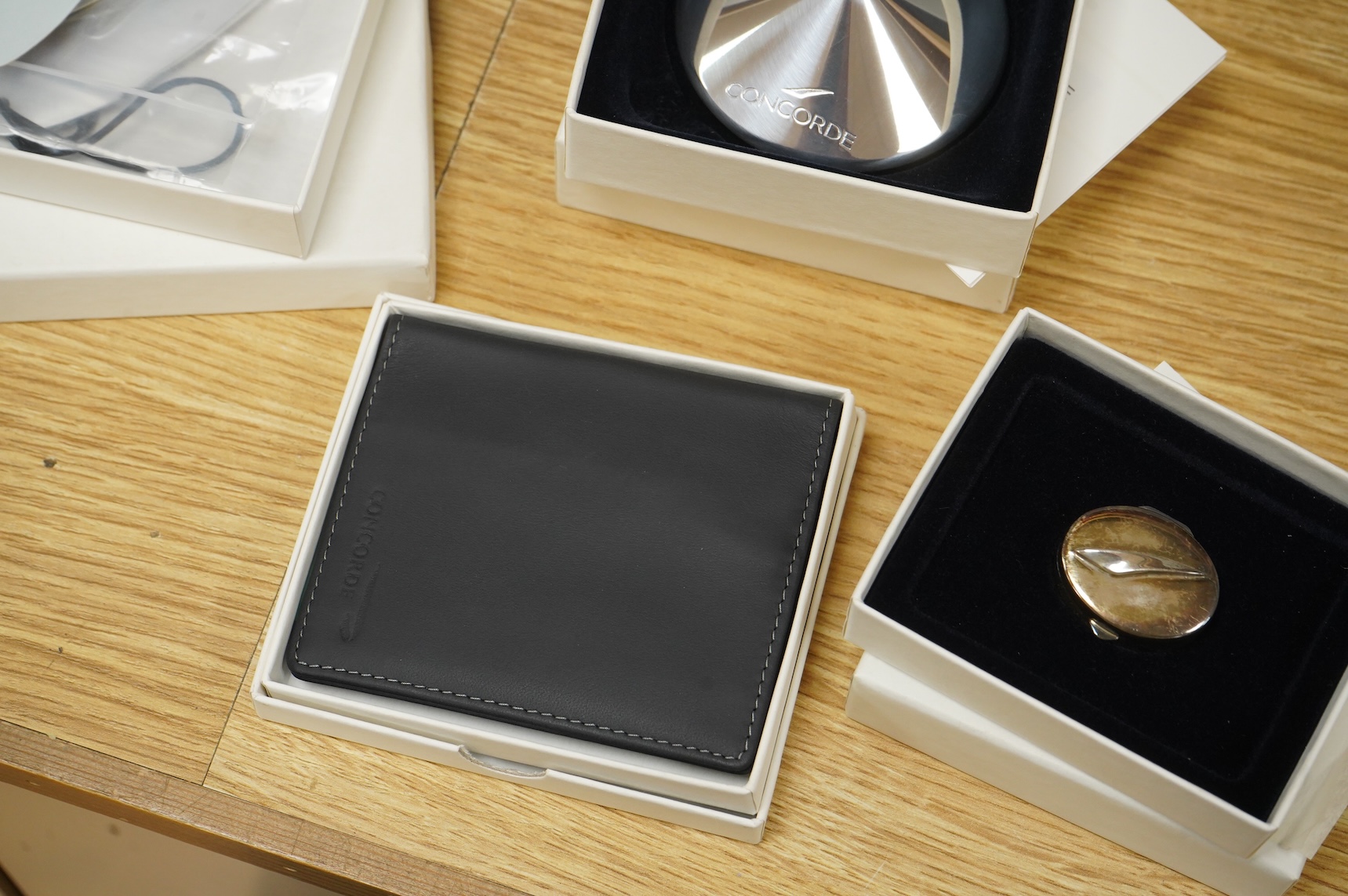 Five boxed British Airways Concorde branded promotional items including; a sterling silver trinket box by Links of London, a hip flask, a bottle opener, a leather credit card holder, and three unused luggage labels